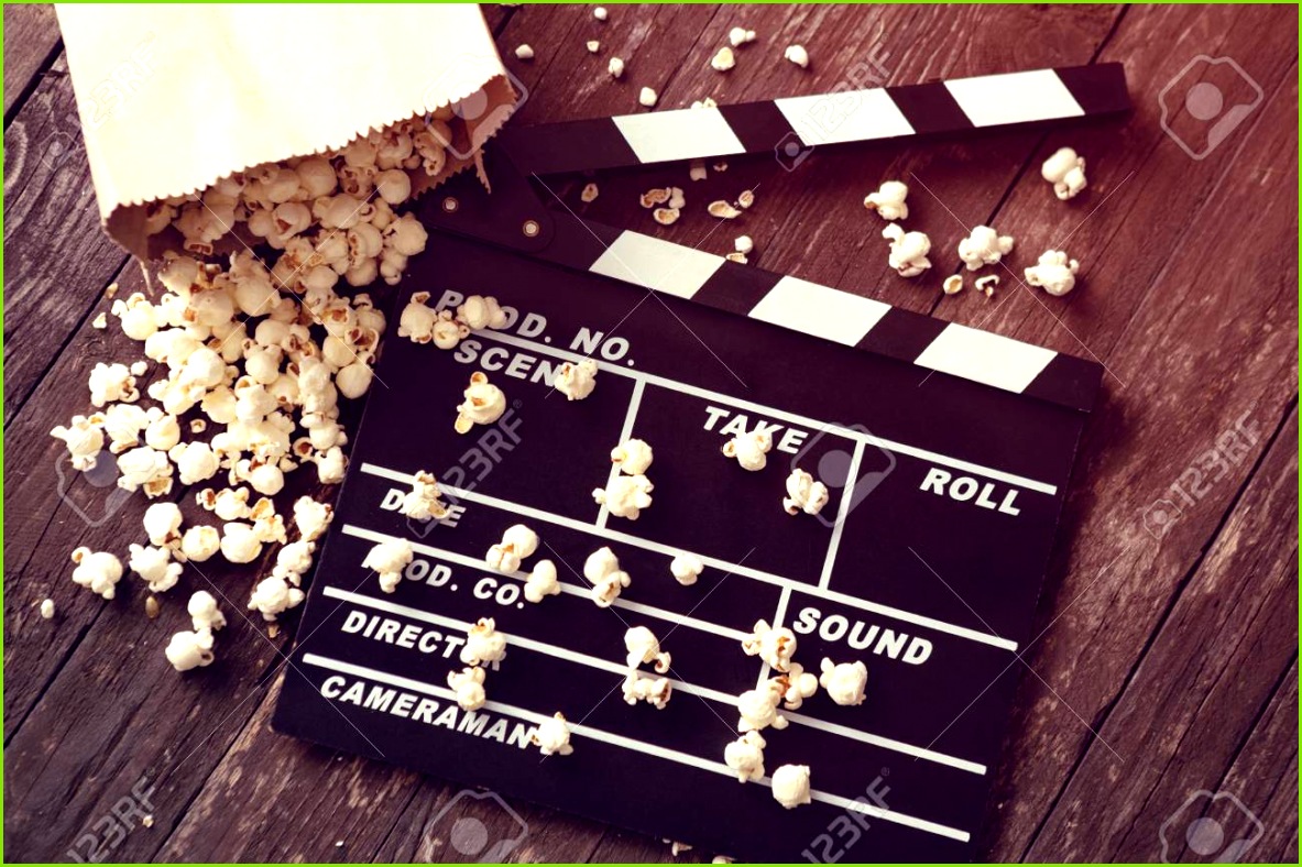 movie clapper board with fresh popcorn Stock