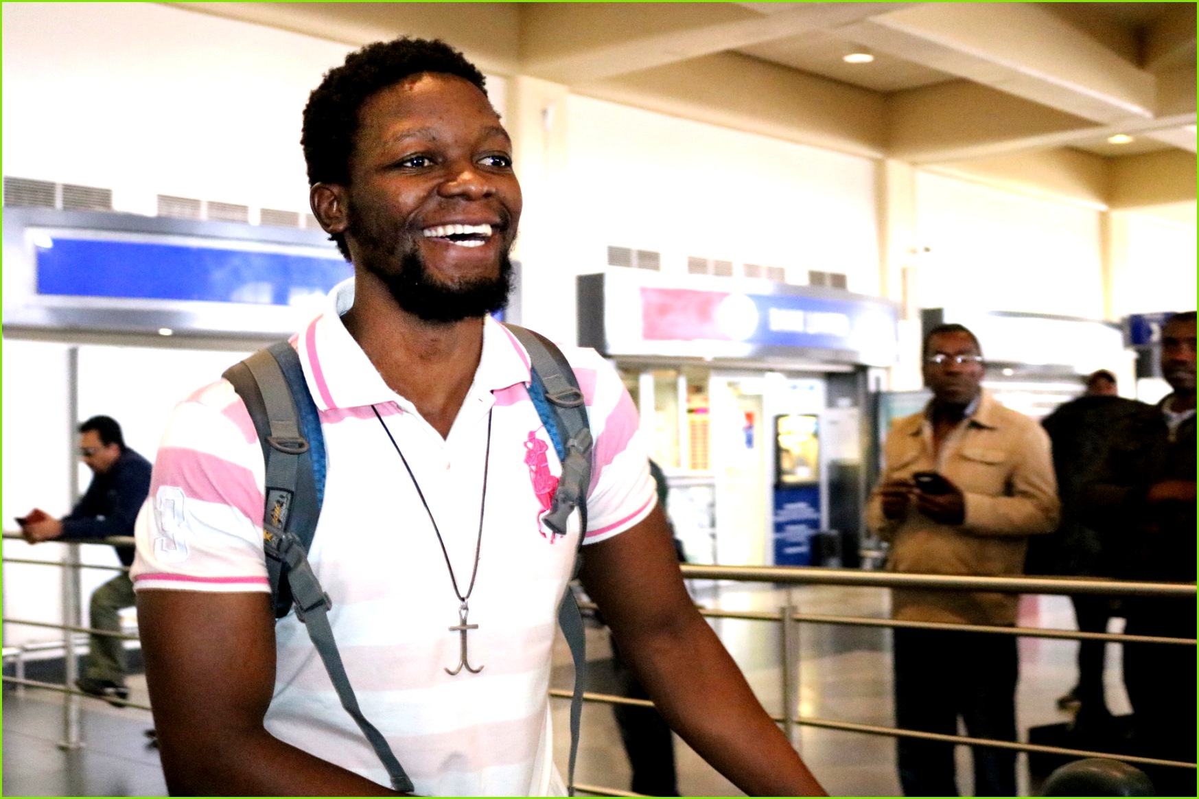 Tawanda Chandiwana exhibits a broad smile as he arrives back home in Zimbabwe in July